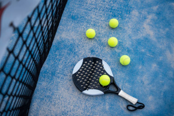 Paddle tennis court, net, racket, balls.